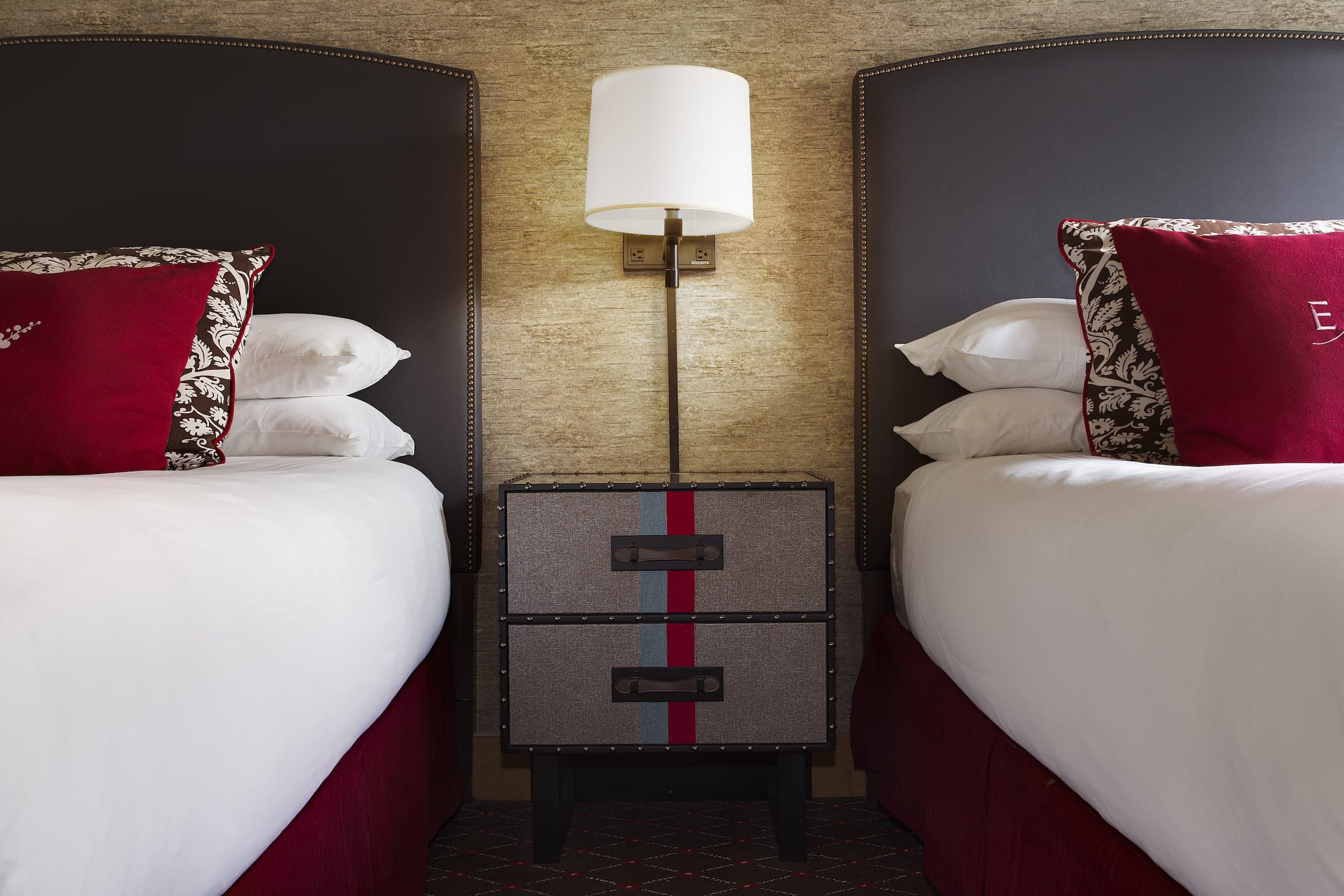 Two beds in a room at Edgewater divided by a nightstand
