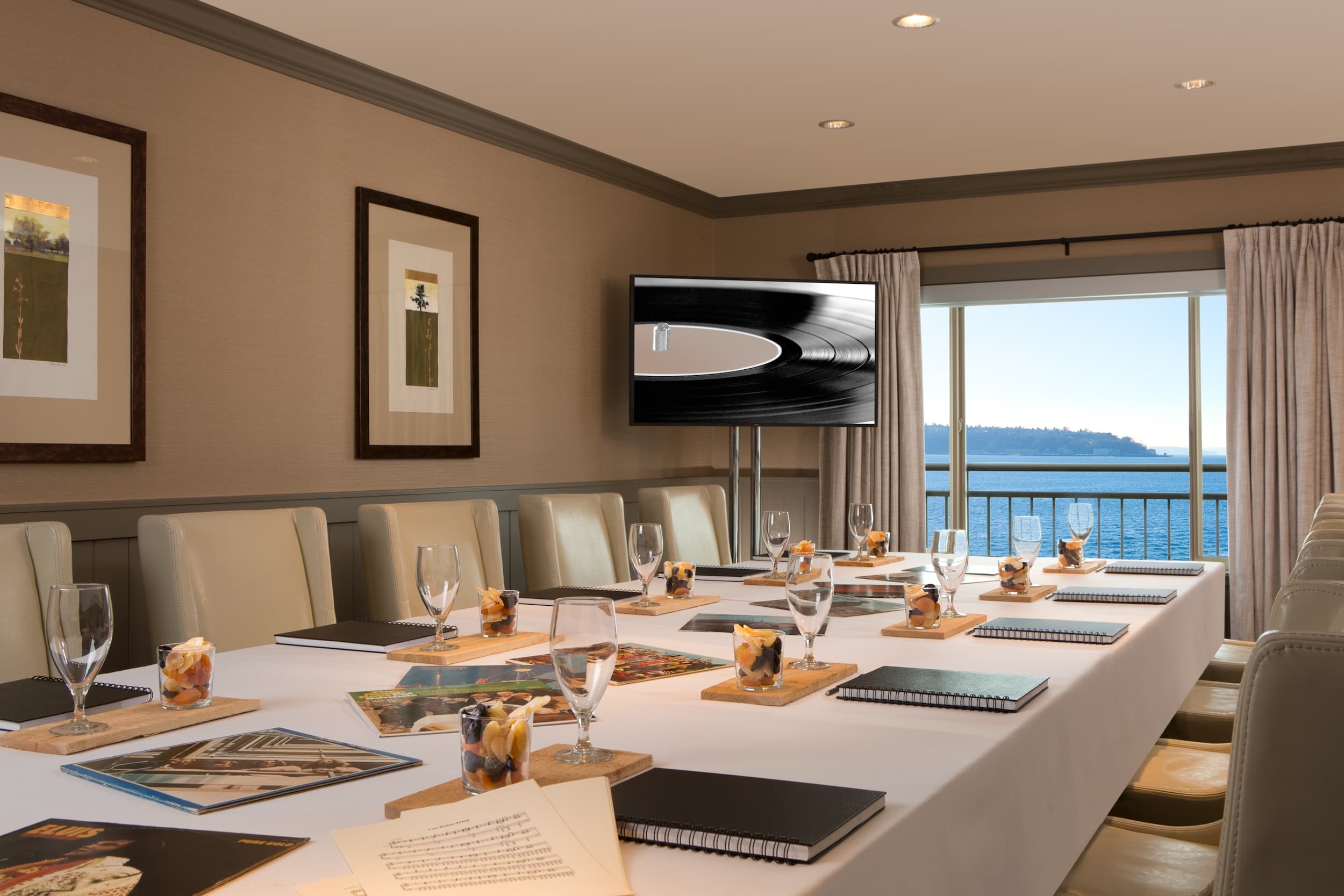 The Orcas, Winslow , and Elliott rooms set up for a meeting with a view of the Ocean