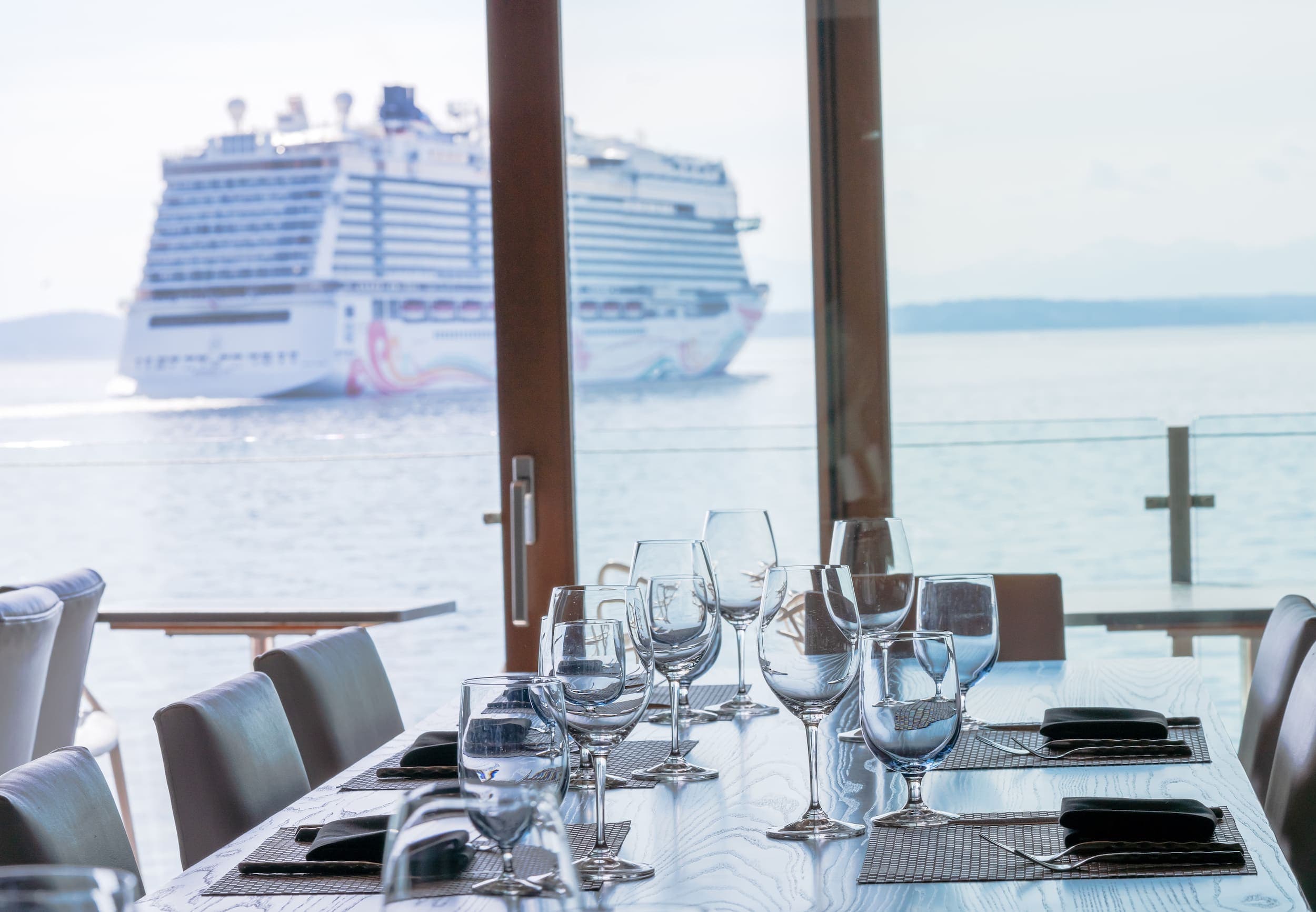 A large table seating 8 guests set up for dinner service at Six Seven Restaurant