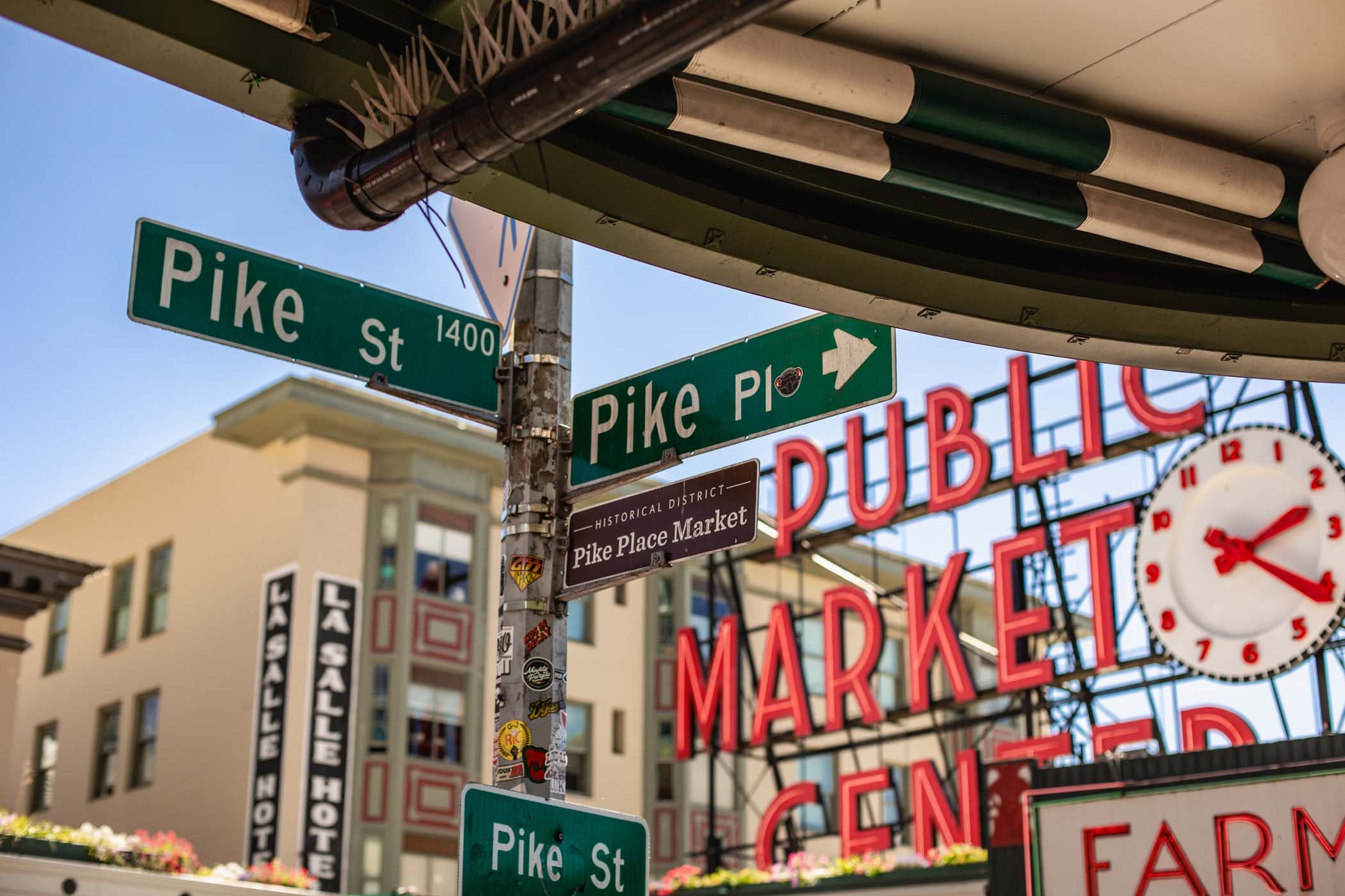 Some street signs with street names on them outside the Public Market Center