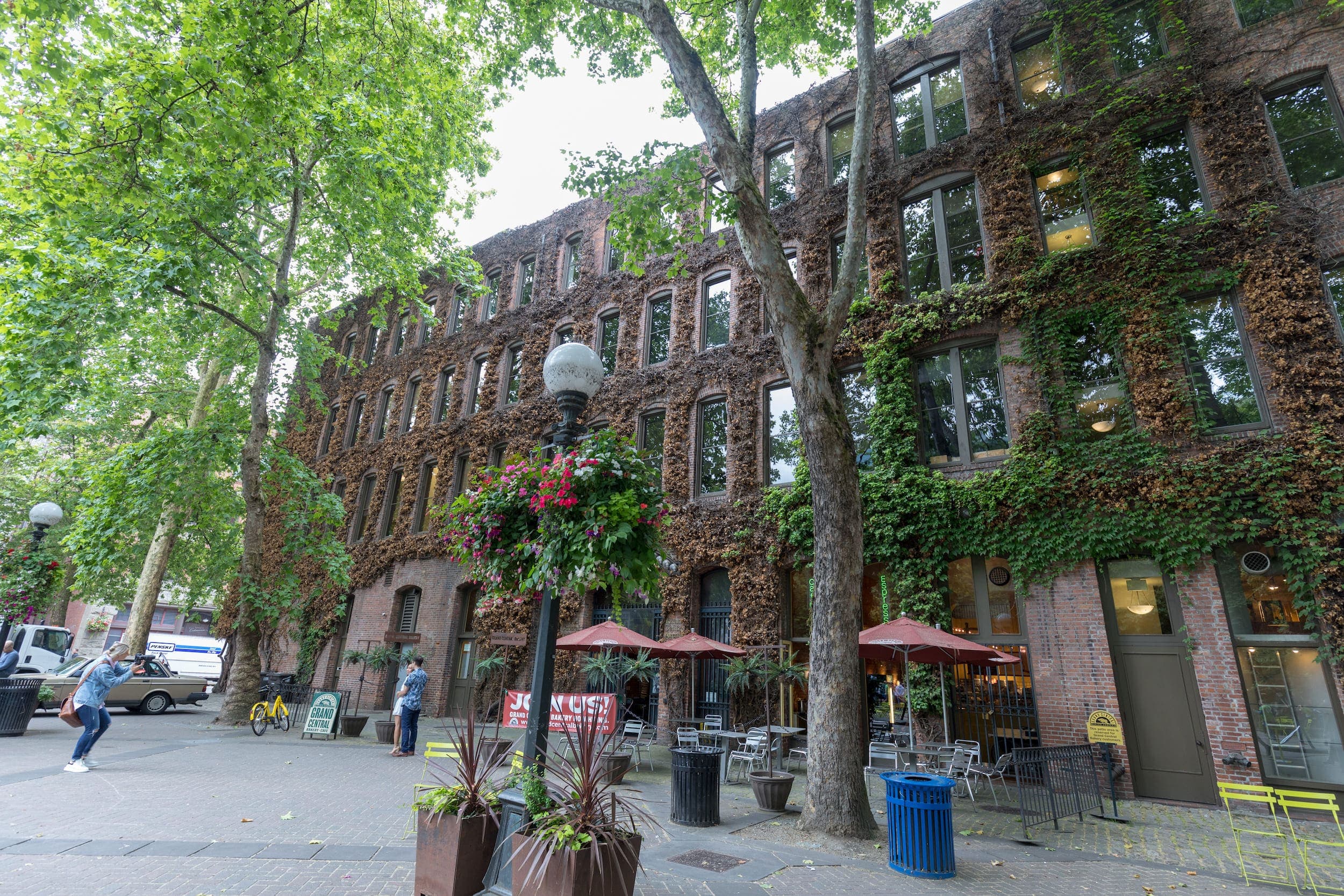 Tourists walking and taking photos of Pioneer Square