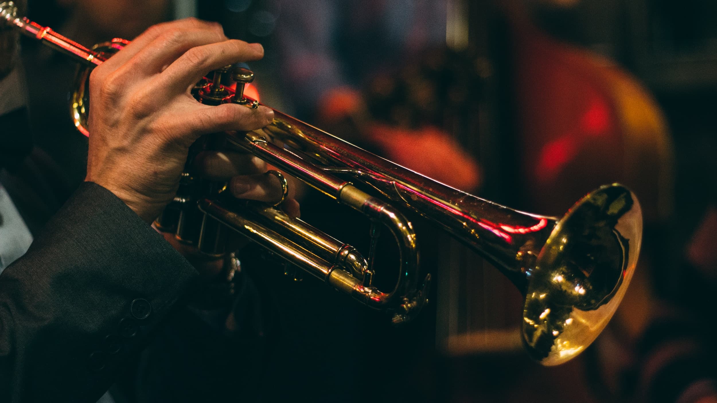 A close up of a person playing a trumpet