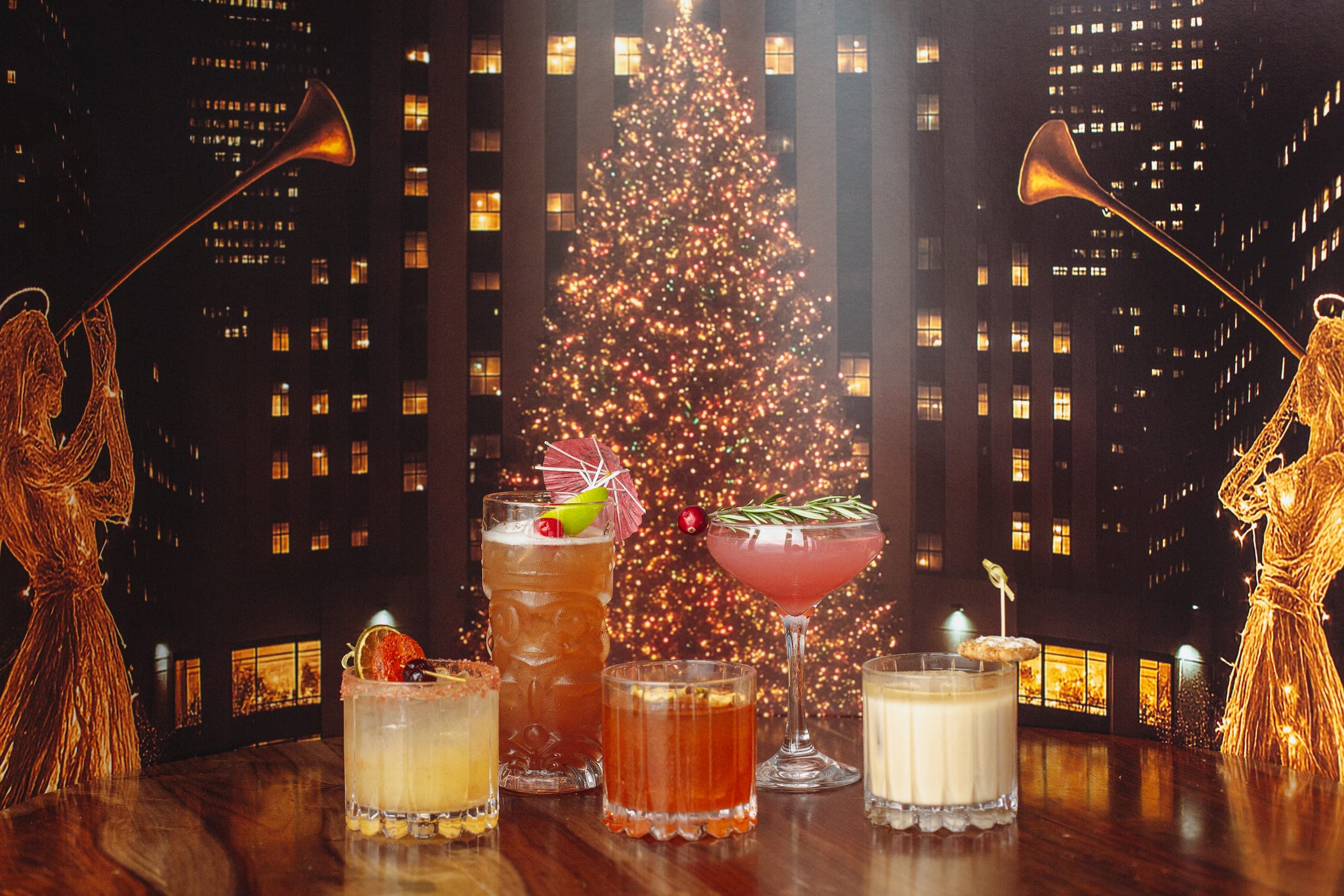 5 cocktails on a wood table with a festive background