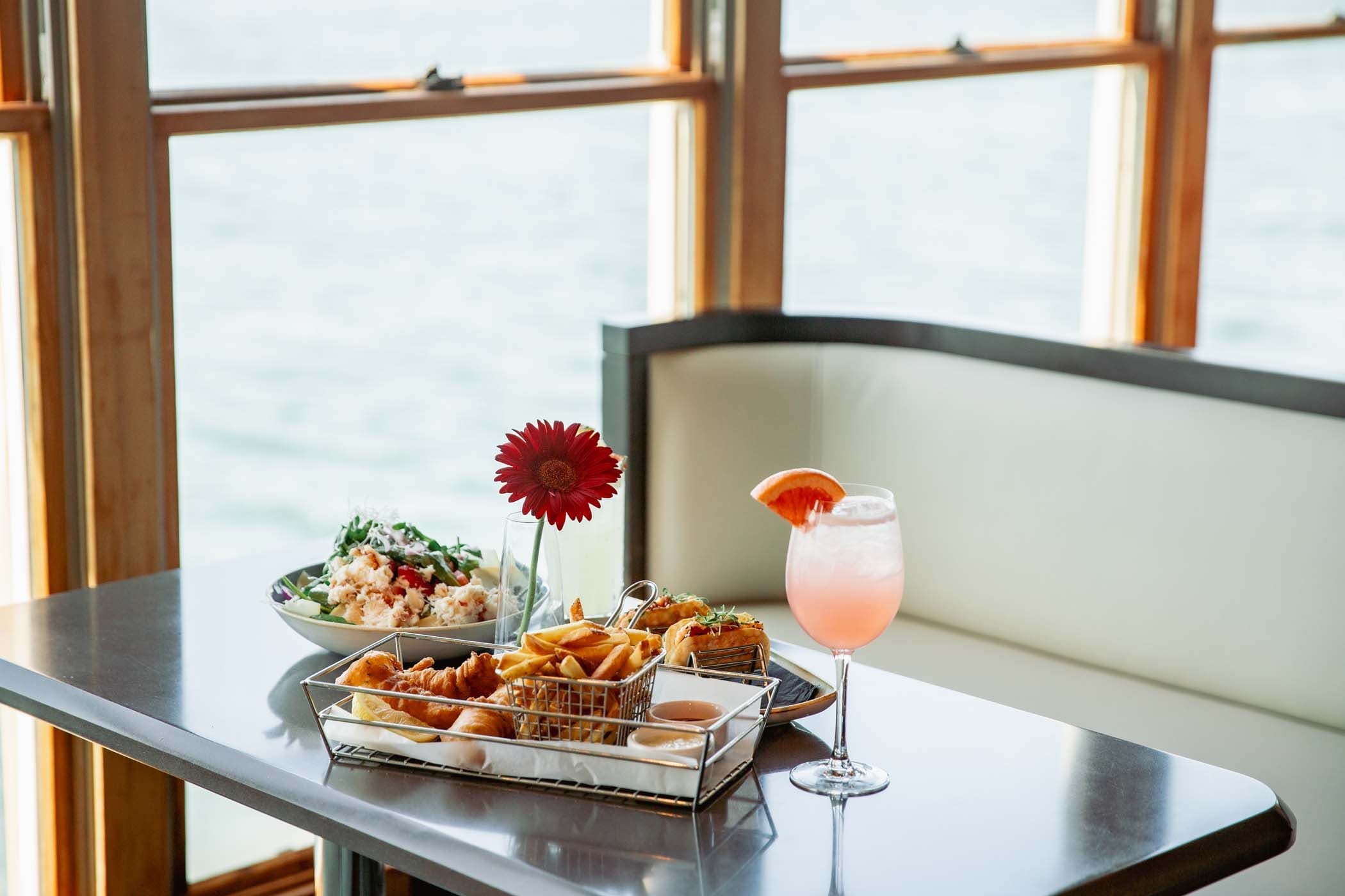 A cocktail, fish and chips, and a salad at Edgewater