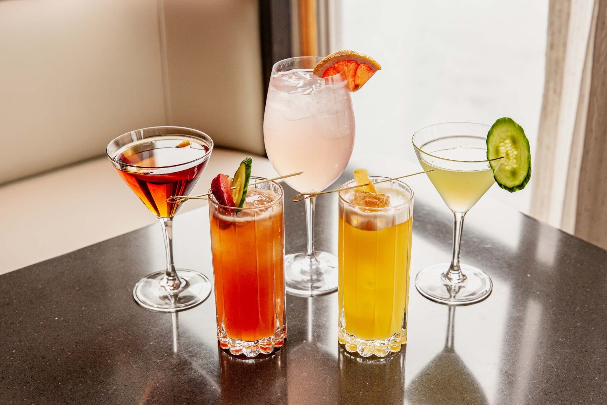 5 different types of cocktails on a table at Six Seven