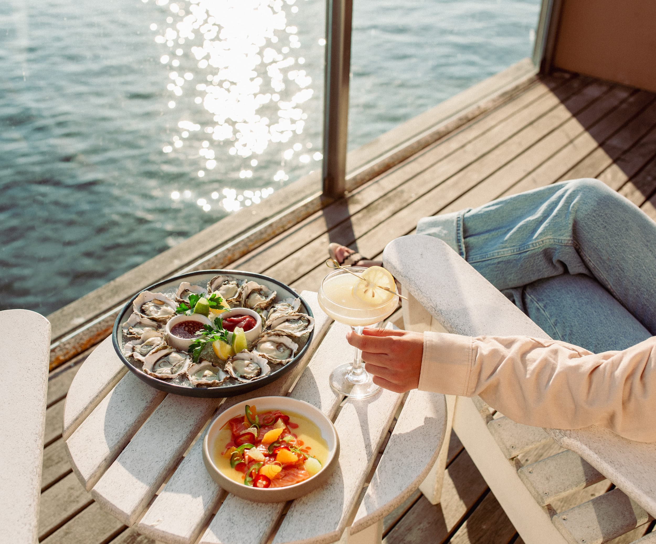 A guest enjoying a cocktail and food in their room