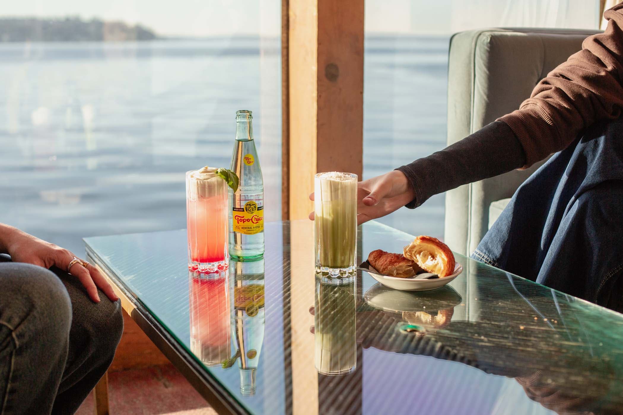 Two beverages on a glass coffee table at The Brin Coffee Shop