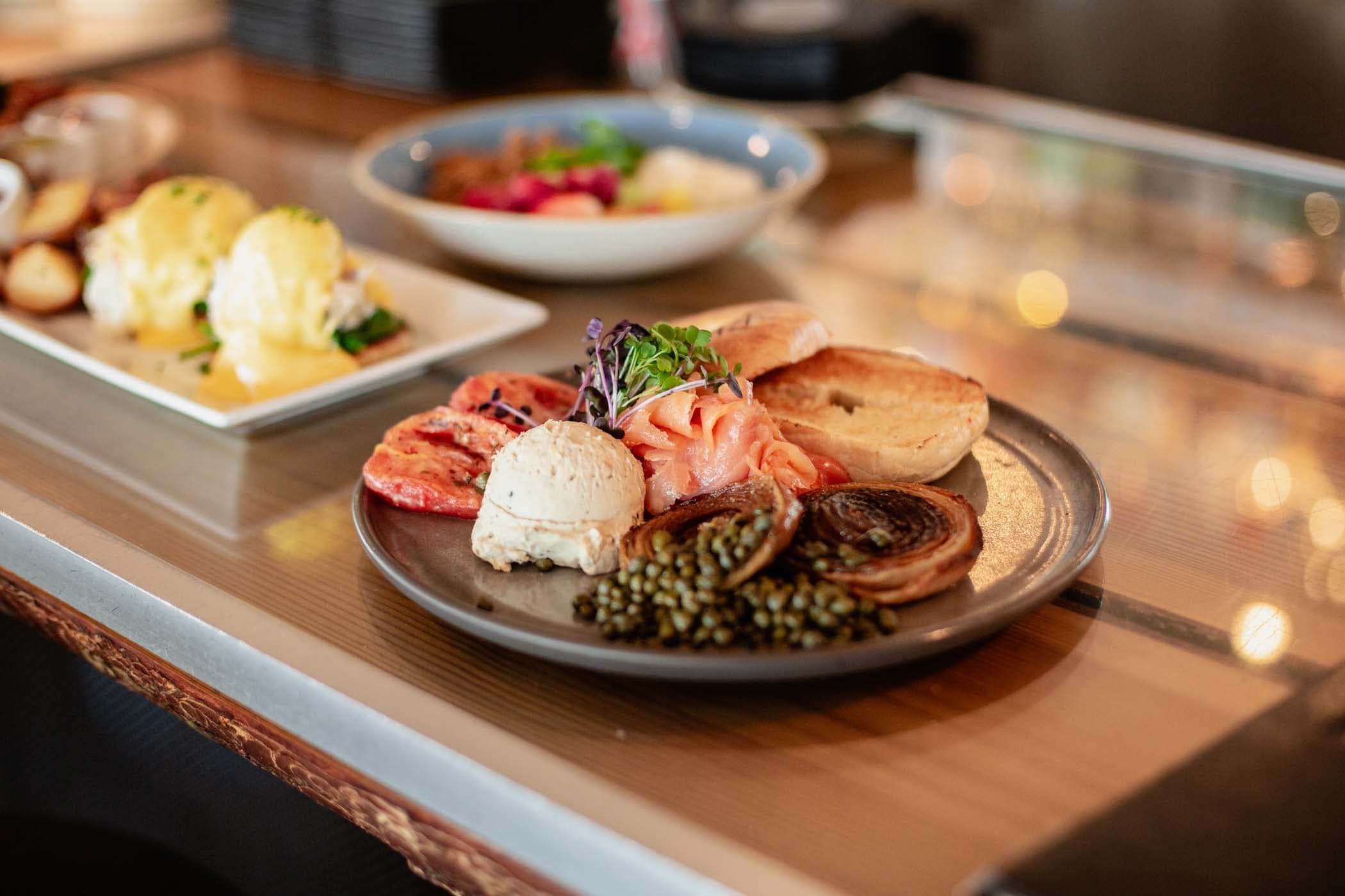 Smoked salmon, capers, cream cheese, grilled tomatoes and a toasted bagel at Six Seven