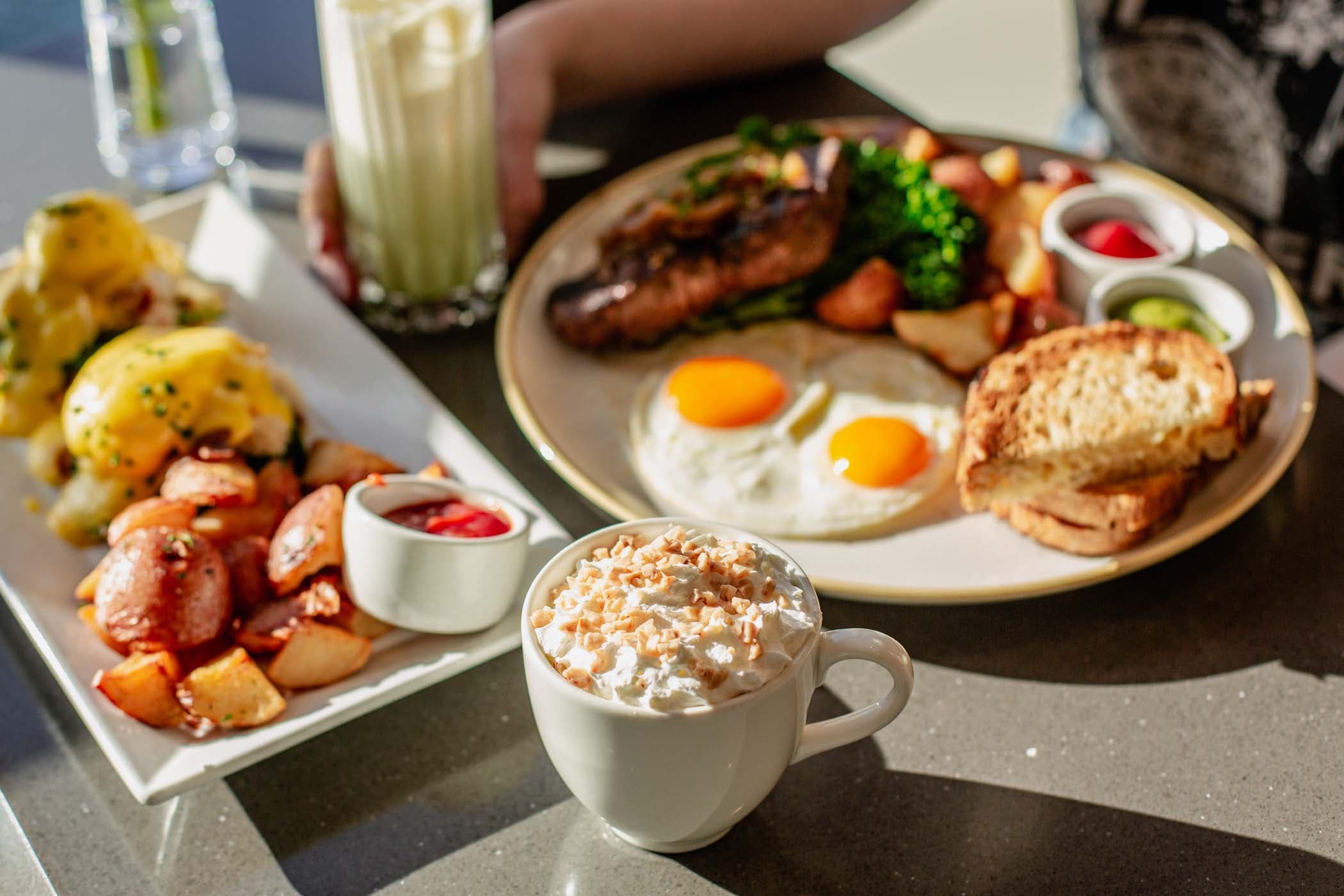 2 breakfast dishes and a hot beverage at Six Seven