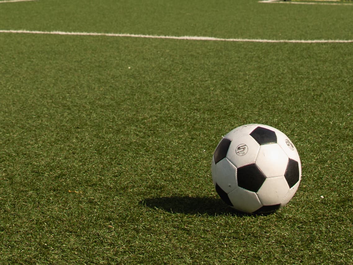 A black and white soccer ball on the field