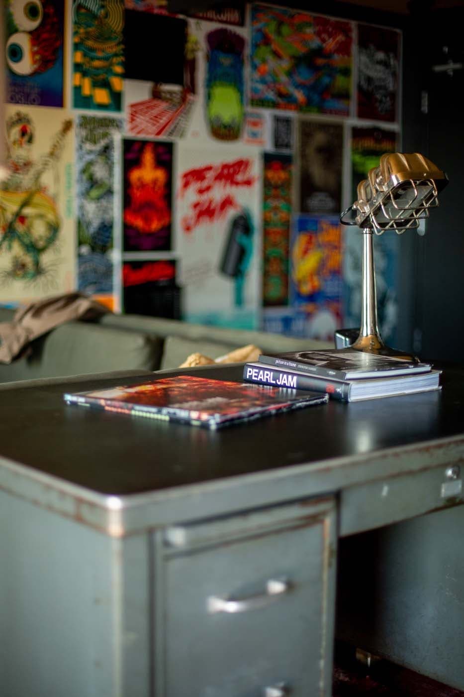 A vintage metal desk with a desk lamp made from an old microphone in the Pearl Jam Suite at Edgewater
