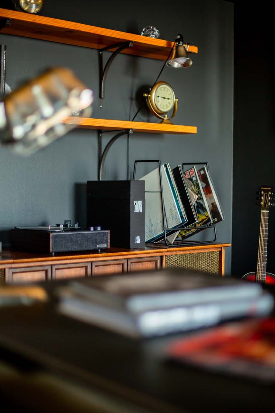 A shelf with a record player and records in the Pearl Jam Suite at Edgewater