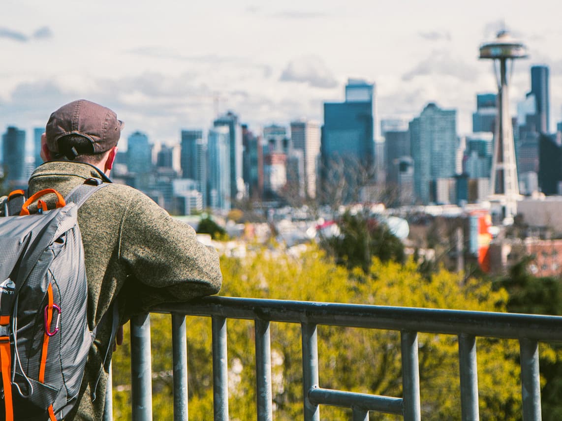 A man looking at Seattle from Kerry park