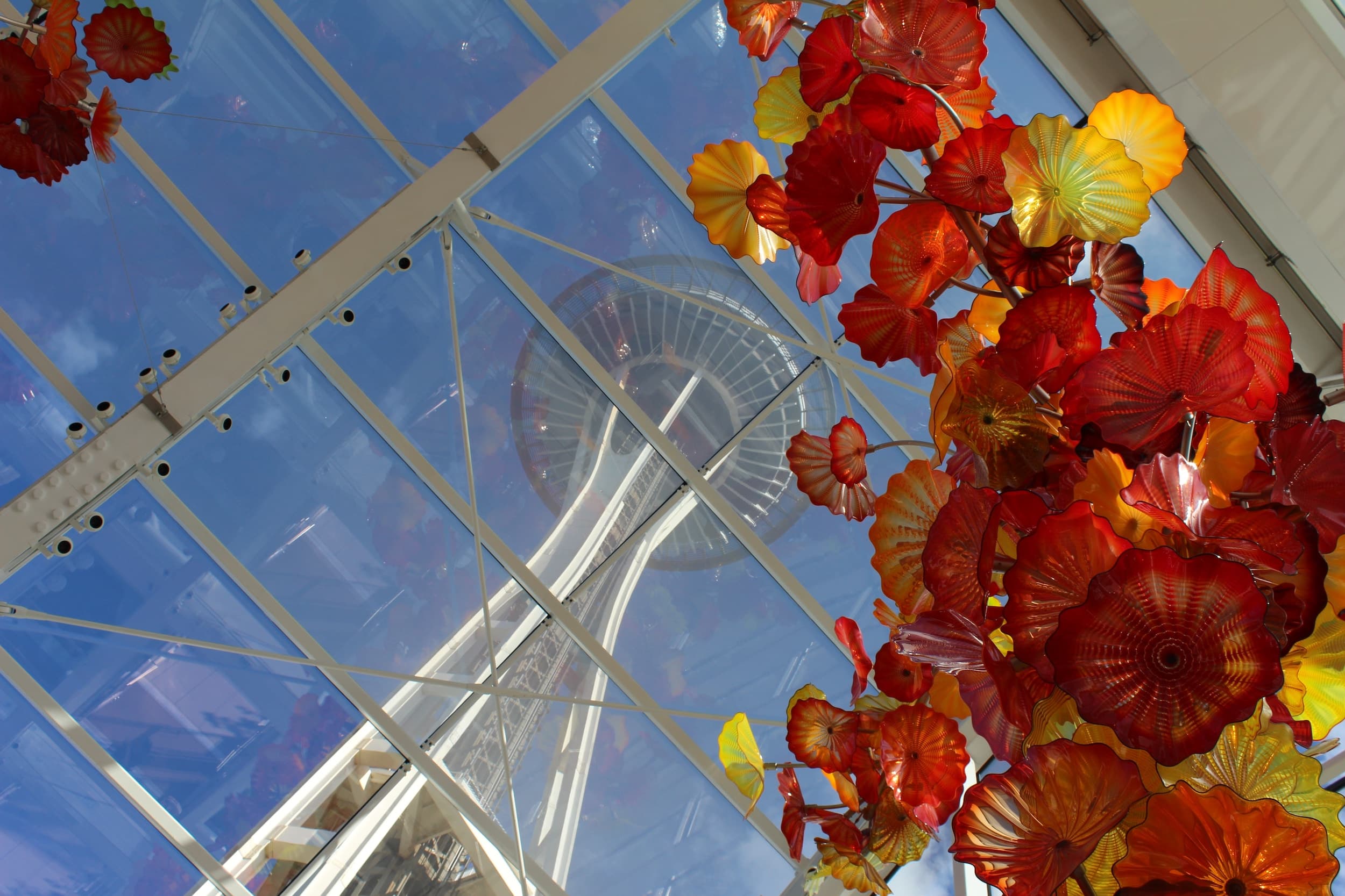 Inside Chihouly filled with glass flowers and a view oof the space needle