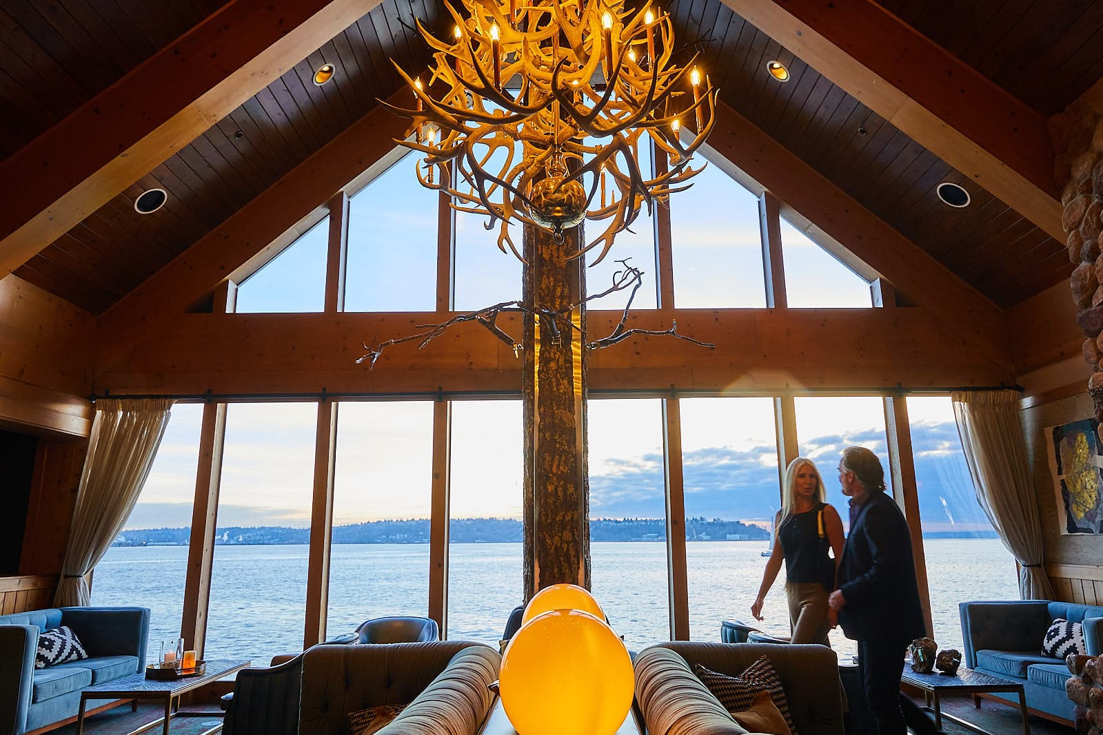 The Edgewater lobby at sunset with teo people walking and talking