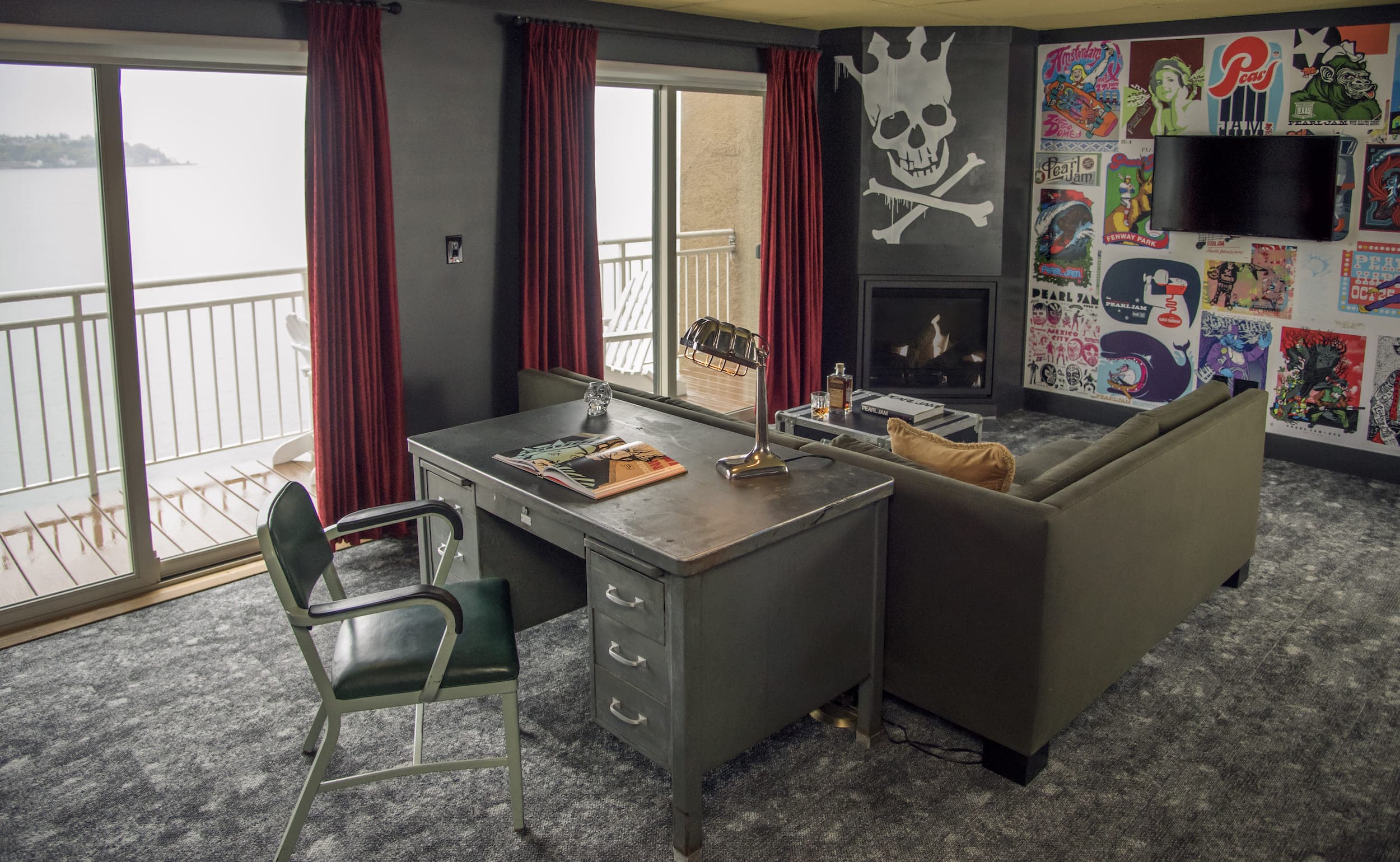 The living space with a large metal desk in the Pearl Jam inspired suite at Edgewater