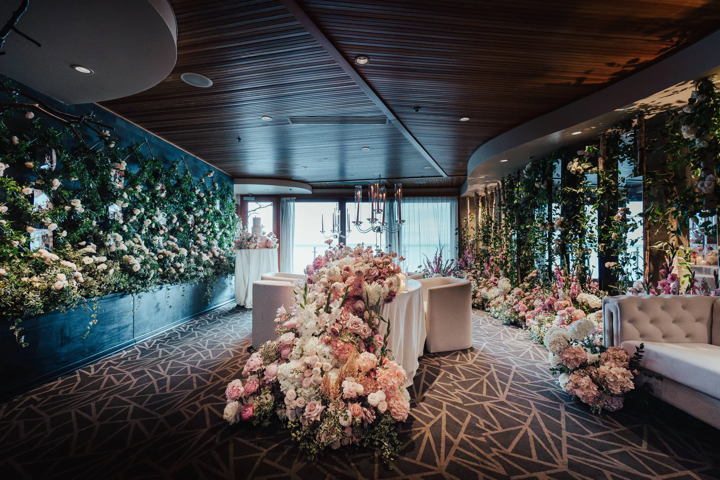 Floral-draped Forest Room wedding reception with waterfront views at The Edgewater Hotel Seattle