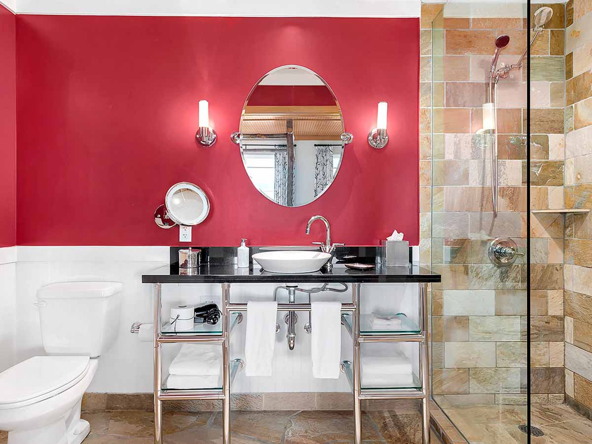 Guest room Bathroom with toilet, sink and shower.