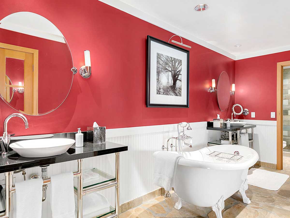 Bathroom with 2 sinks and bath.