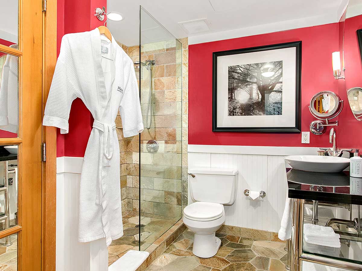 Guest room Bathroom with toilet, sink and shower.