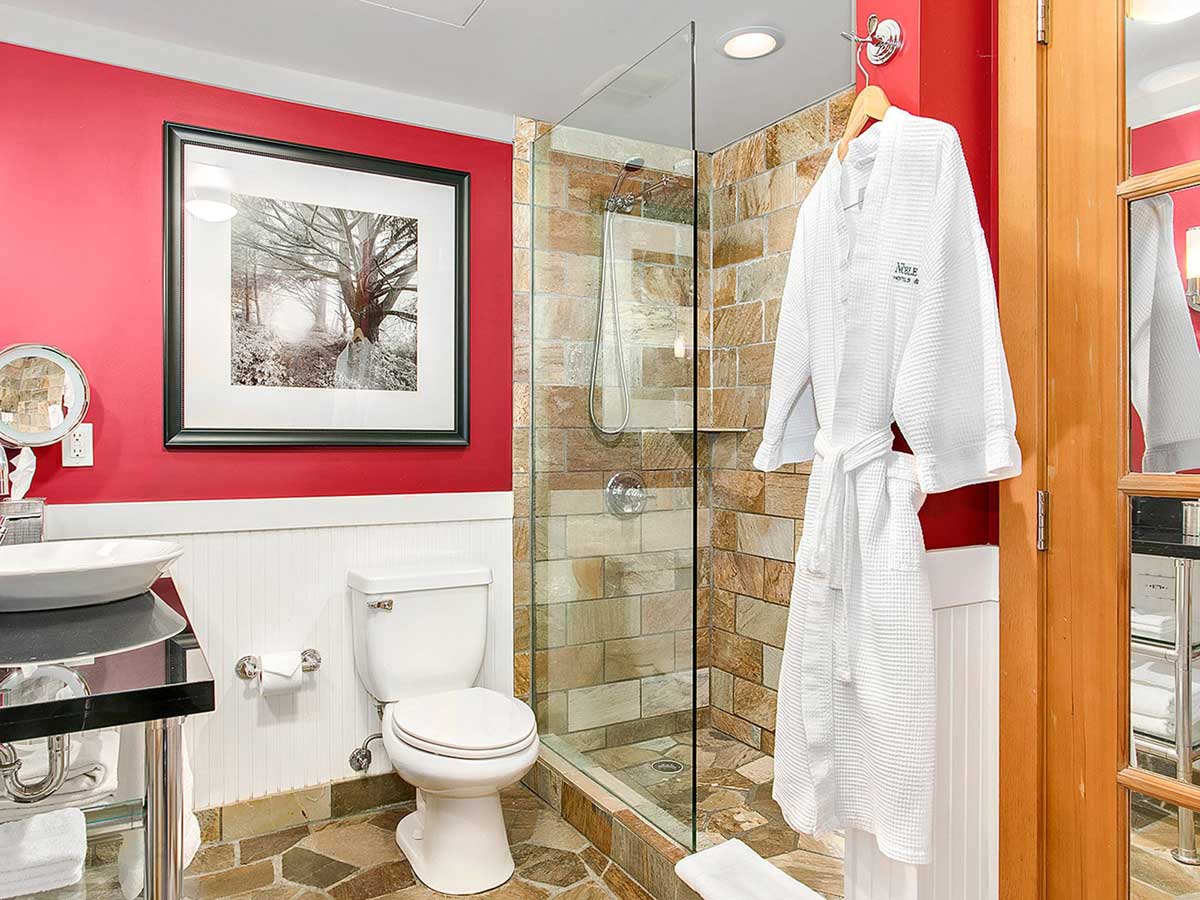 Guest room Bathroom with toilet, sink and shower.