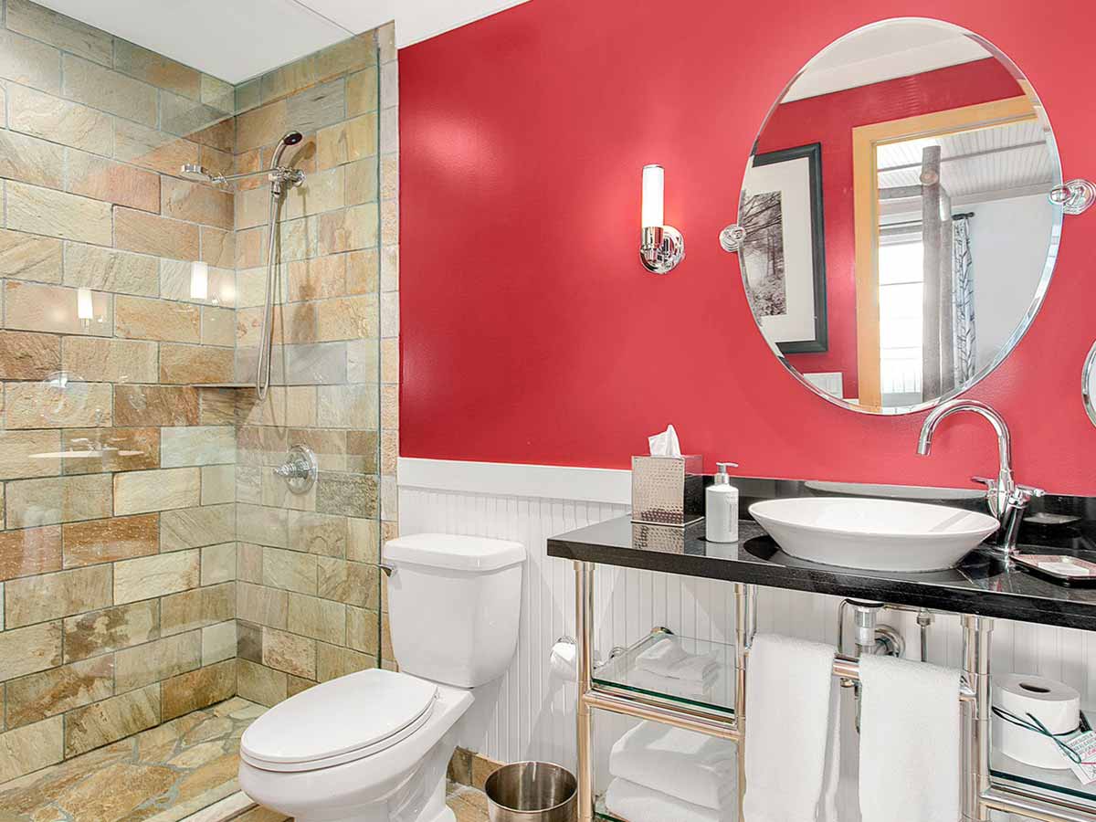 Guest room Bathroom with toilet, sink and shower.