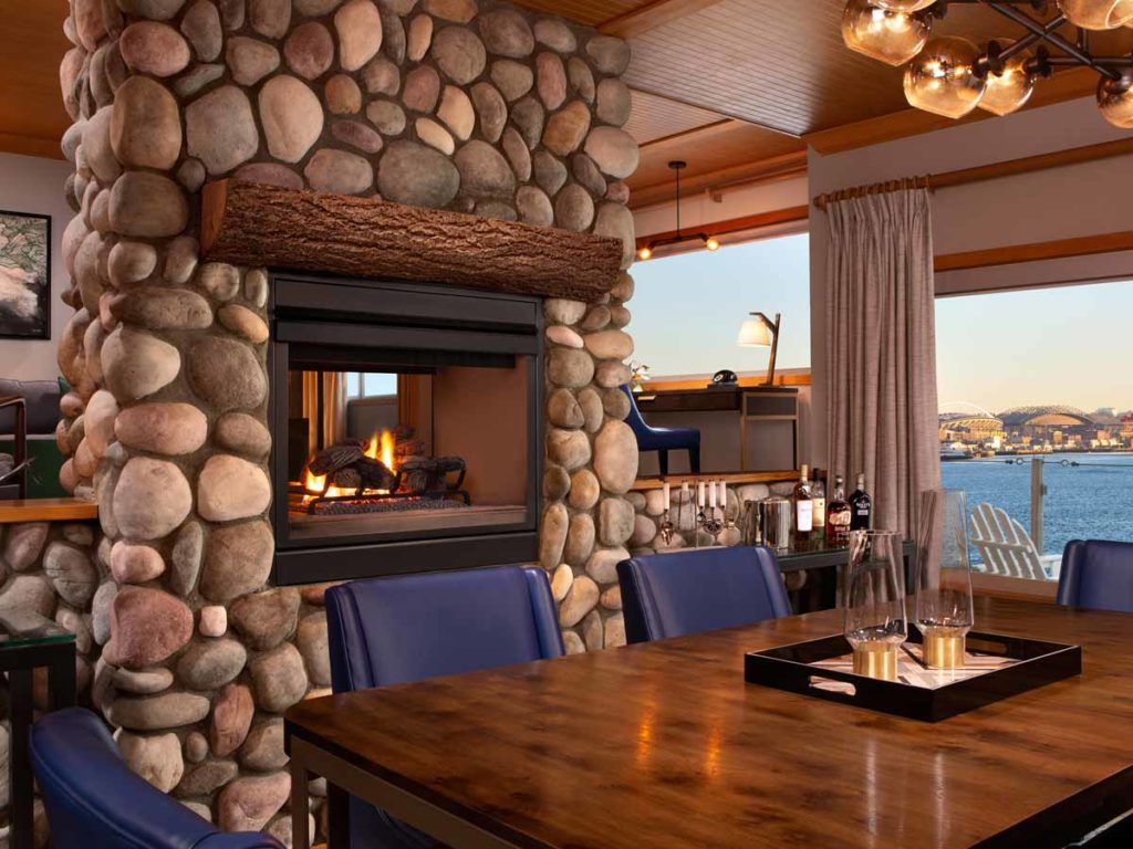 Penthouse eating area with fire place and waterview.
