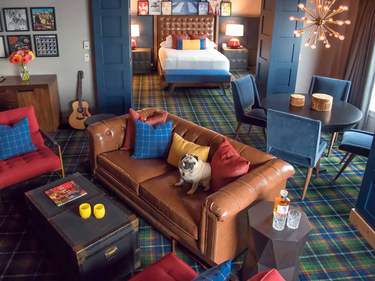 Beatles suite room with sofa, bed, dining table.