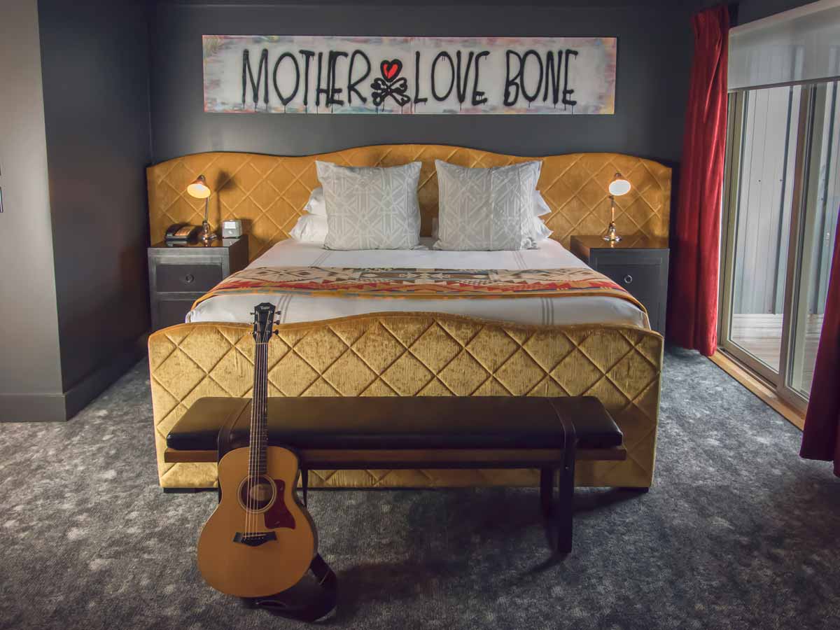 Perl Jam guestroom bed with guitar.