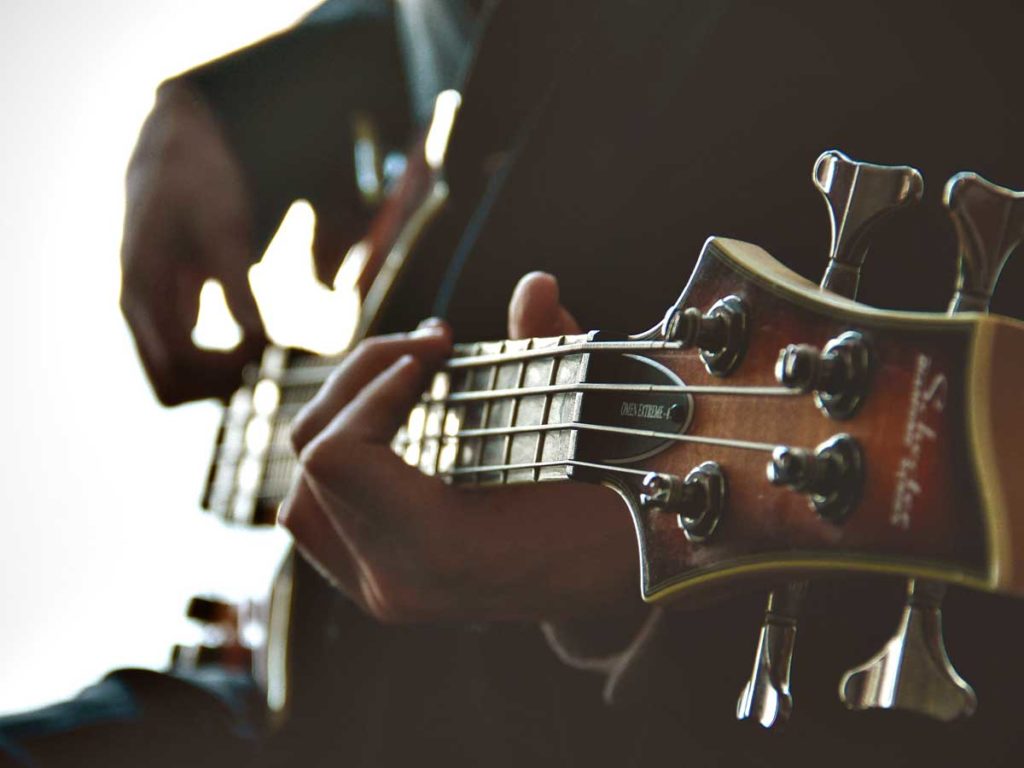 An artist playing the guitar, in Seattle