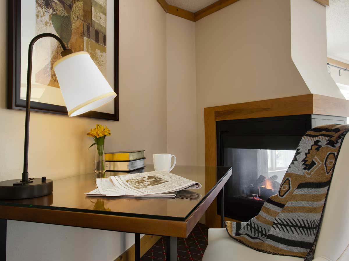 Guest room desk and fireplace.