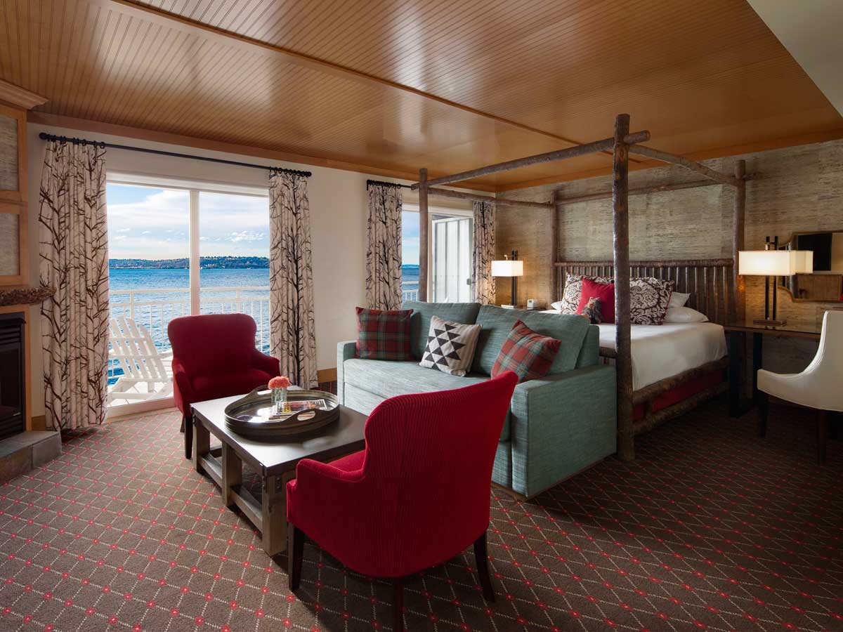 Guest room bed, sitting area and waterview.