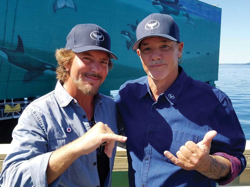 Pearl Jam doing the hang loose sign.