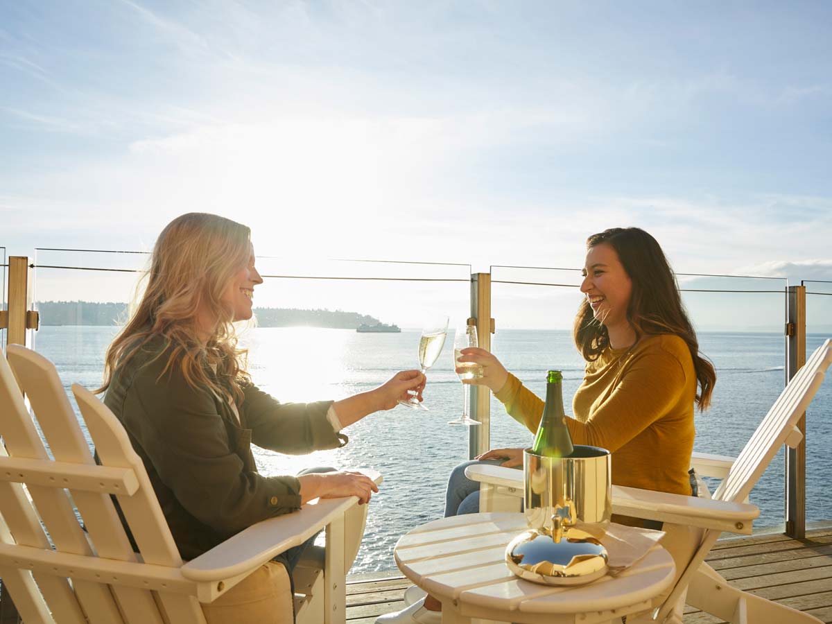 Friends Lounging With Drinks Outside At The Edgewater.