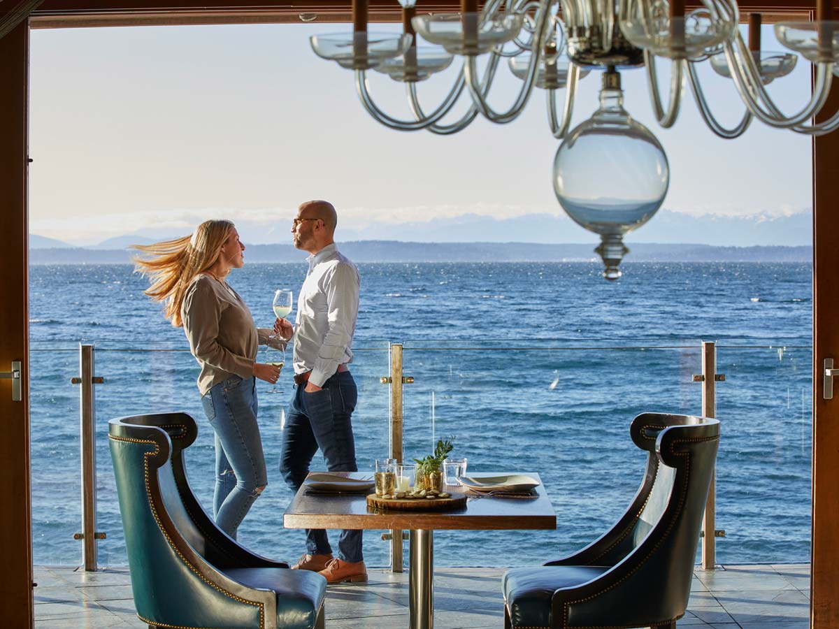 Couple Dining On The Balcony With An Ocean View.