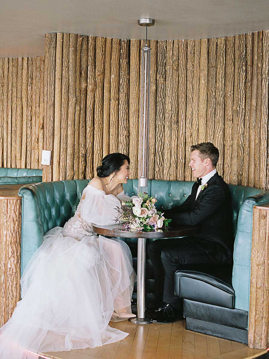 Bride And Groom In A Restaurant Booth.