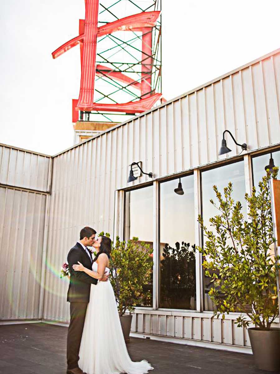 Bride And Groom In Front Of The Edgewater Sign.