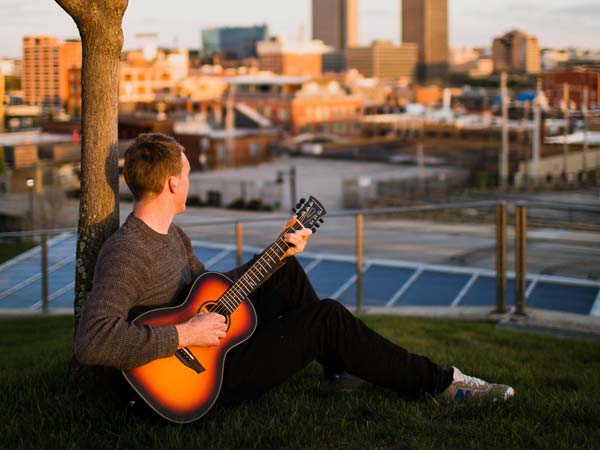 Guy Playing A Guitar In Seattle.
