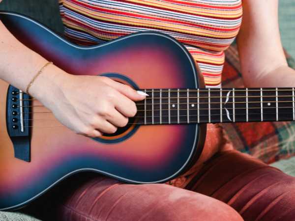 Woman's hand playing a guitar