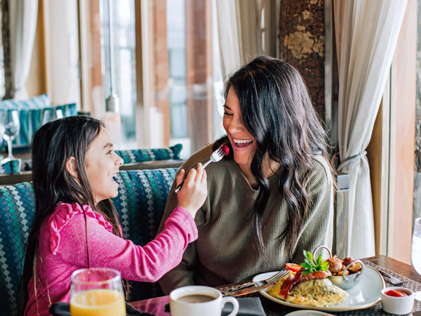 Mother And Daughter Eating At Six Seven.