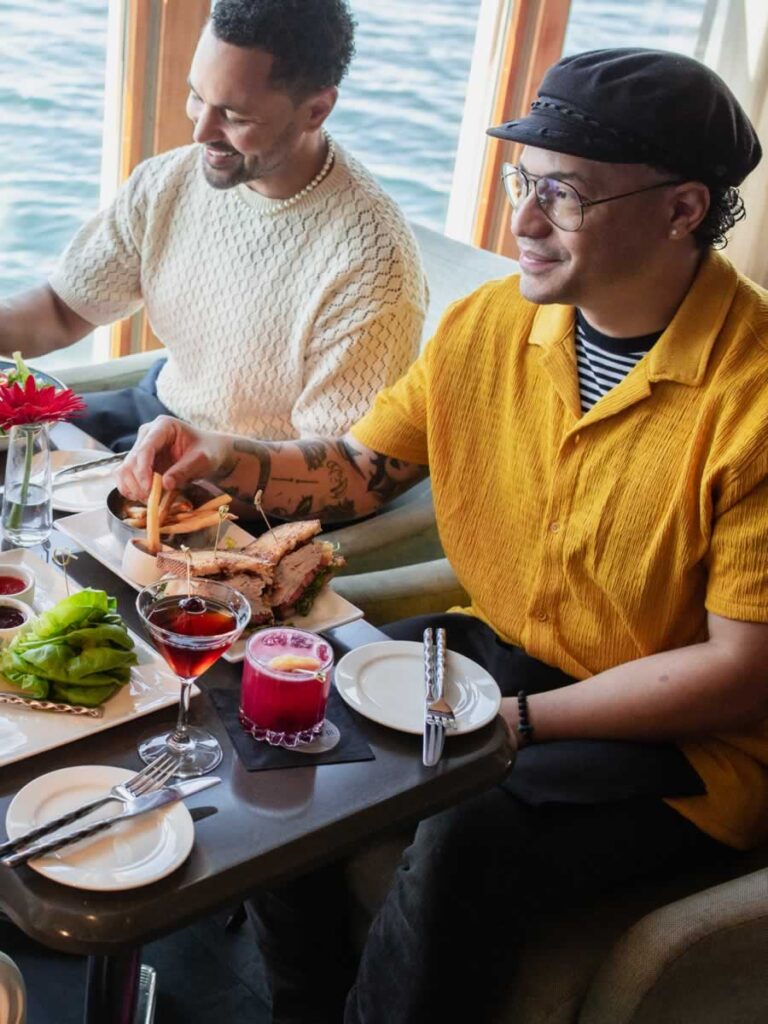 Friends dining with a view of Puget Sound at the Edgewater Hotel